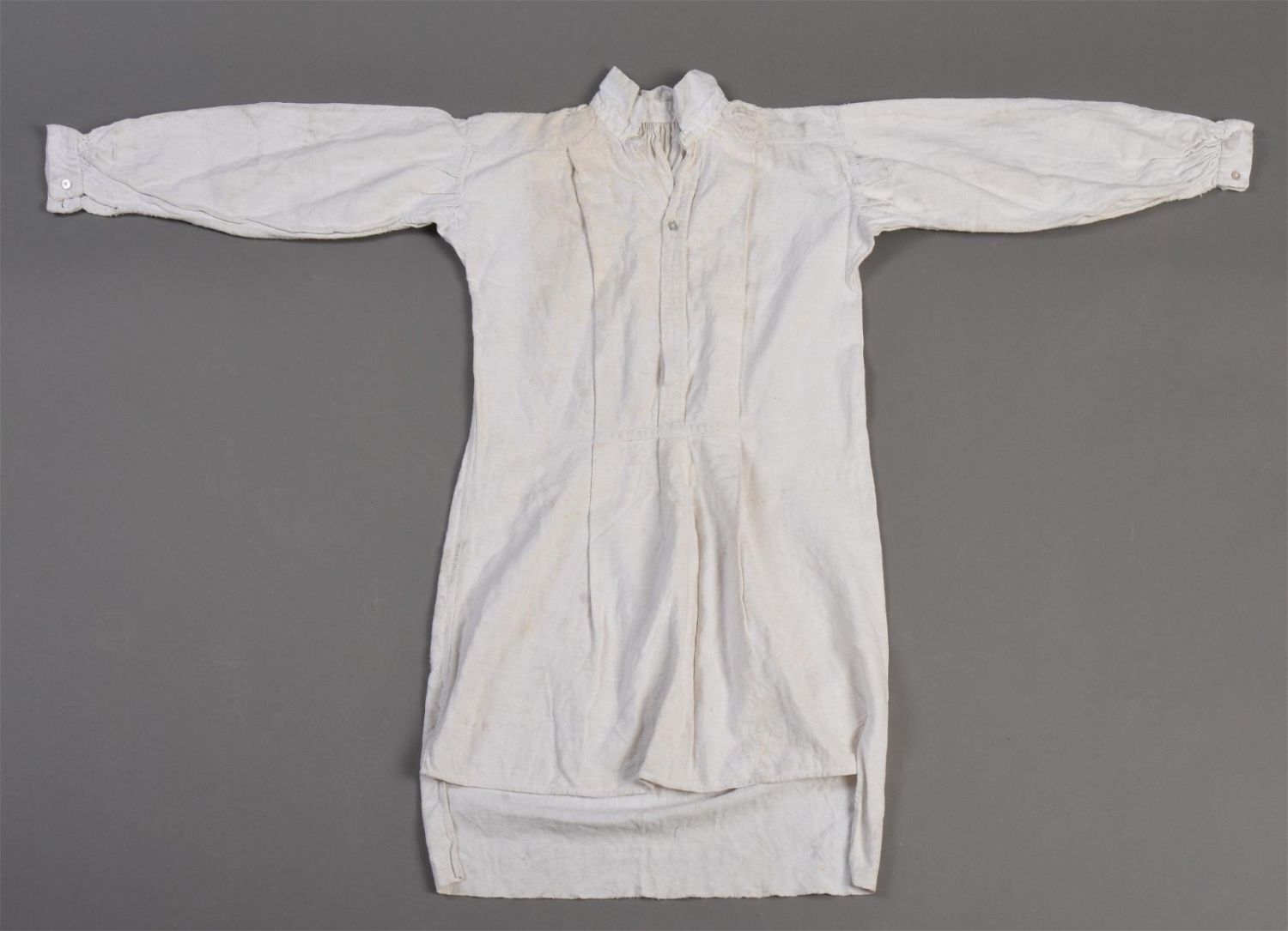 Unbranded early nineteenth-century shirt laid flat as a visual reference for the historical shirting context of Oxford cloth.