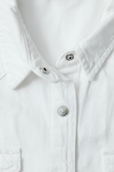 White blouse front placket and button closure detail