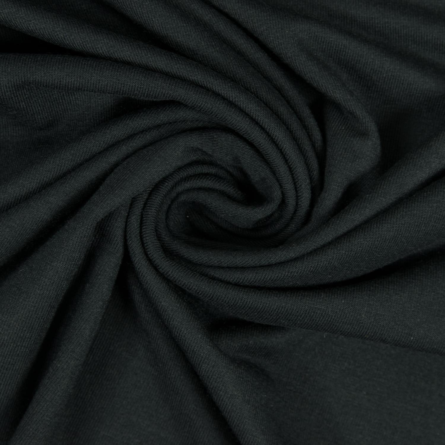 Black TENCEL Modal jersey arranged in soft folds, showing a smooth fine-knit surface and fluid drape.