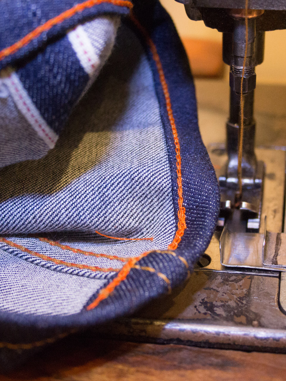 Heavy denim hem being chainstitched