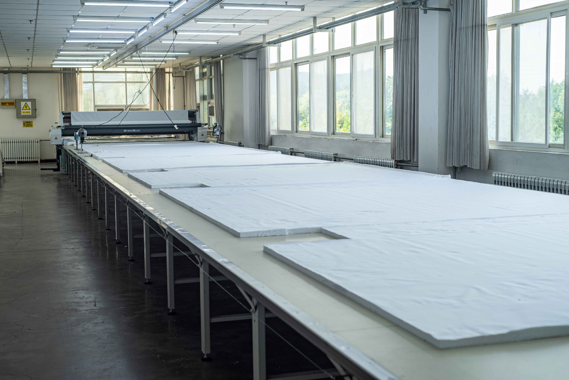 Industrial cutting table with spread fabric ready for cutting