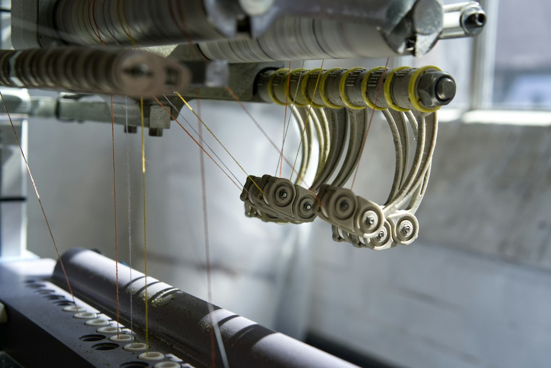 Industrial knitting machine used to form knitted fabric.
