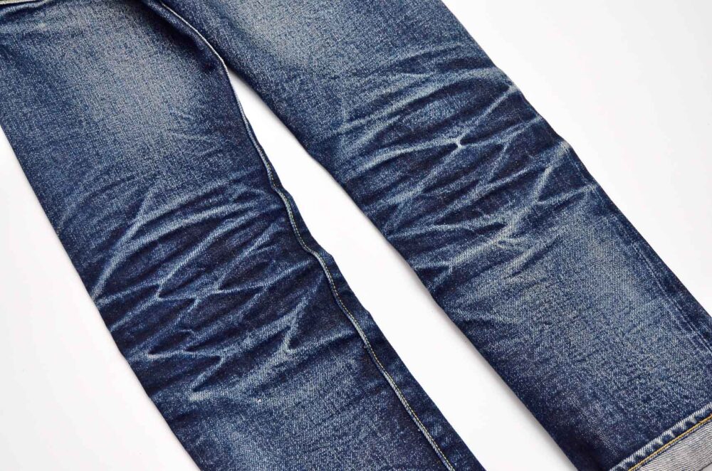 Raw denim with whiskers and honeycomb fades