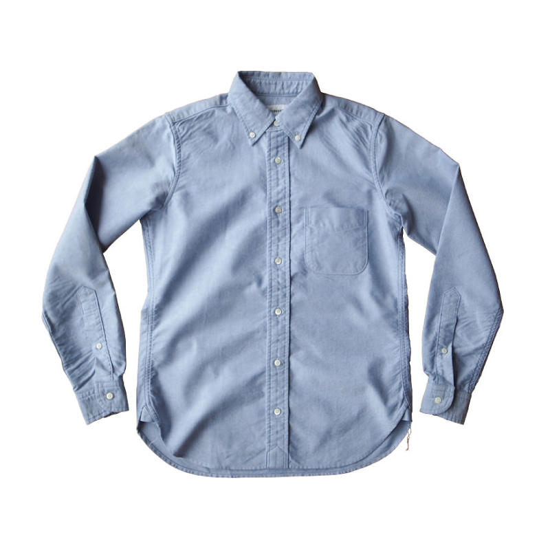 Light blue Oxford button-down shirt laid flat, showing collar, placket, pocket and cuffs without visible branding.