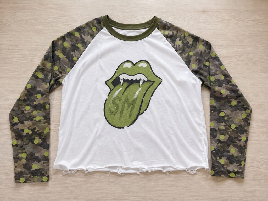 Customer-provided reference image — Making a complex reference work: camo sleeves, statement print, one garment