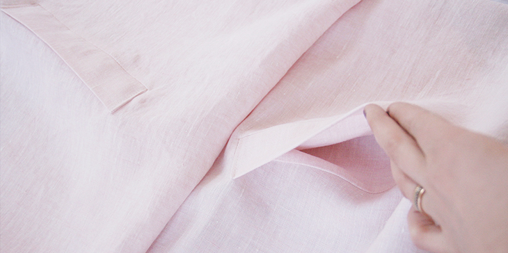 Pocket construction reference: a welt opening and pocket bag on a pale linen trench coat panel