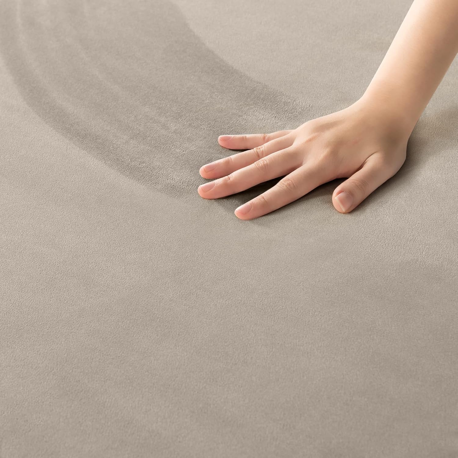 A hand moving across velvet leaves a darker path where the nap has changed direction.