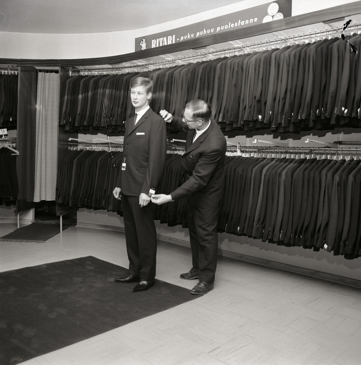 A sleeve being measured during a garment fitting, illustrating the sample-check process for grading and fit
