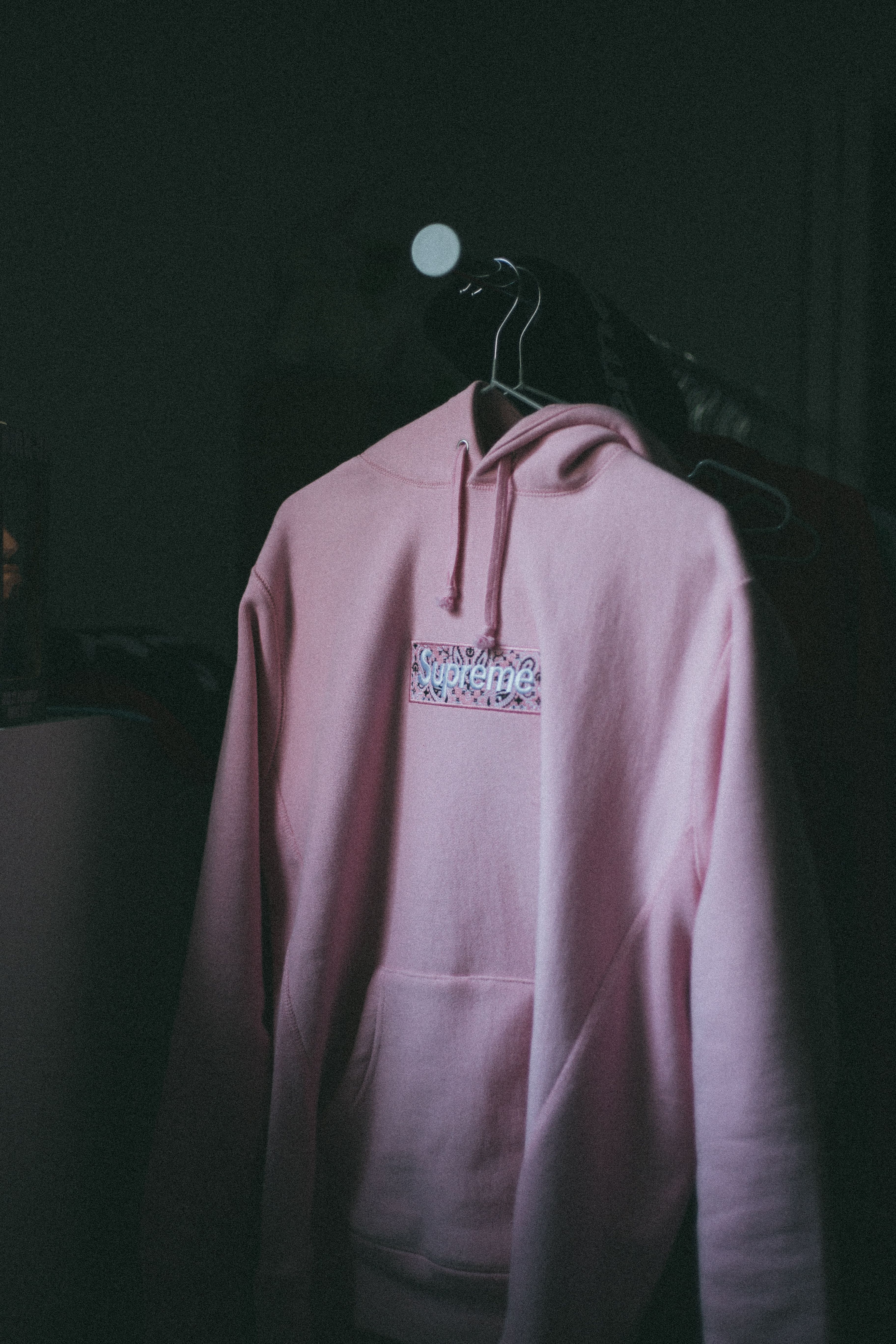 An existing pullover showing its hood, front graphic and pouch pocket.