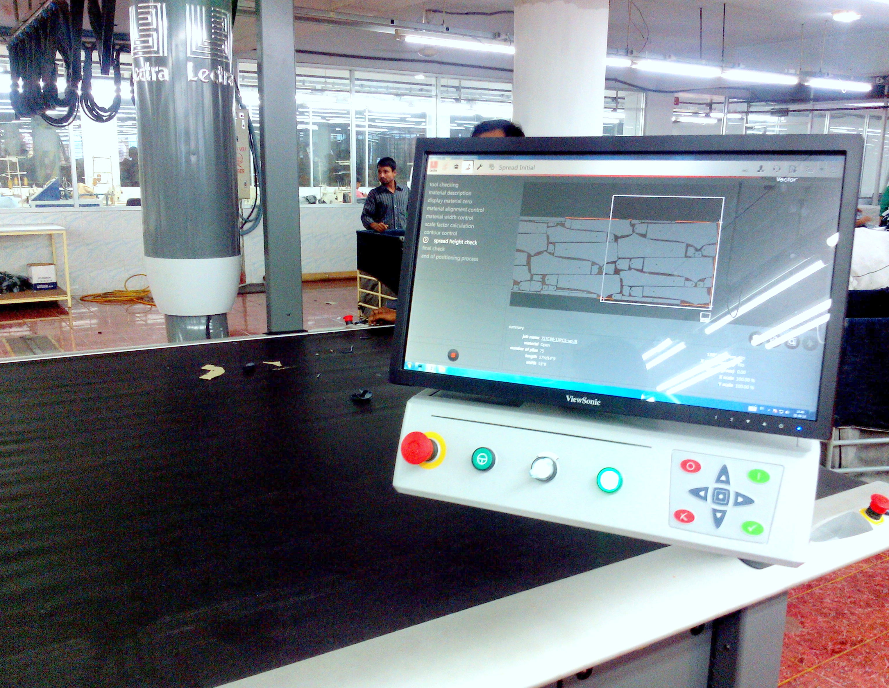 Automatic denim fabric cutting machinery inside a garment factory