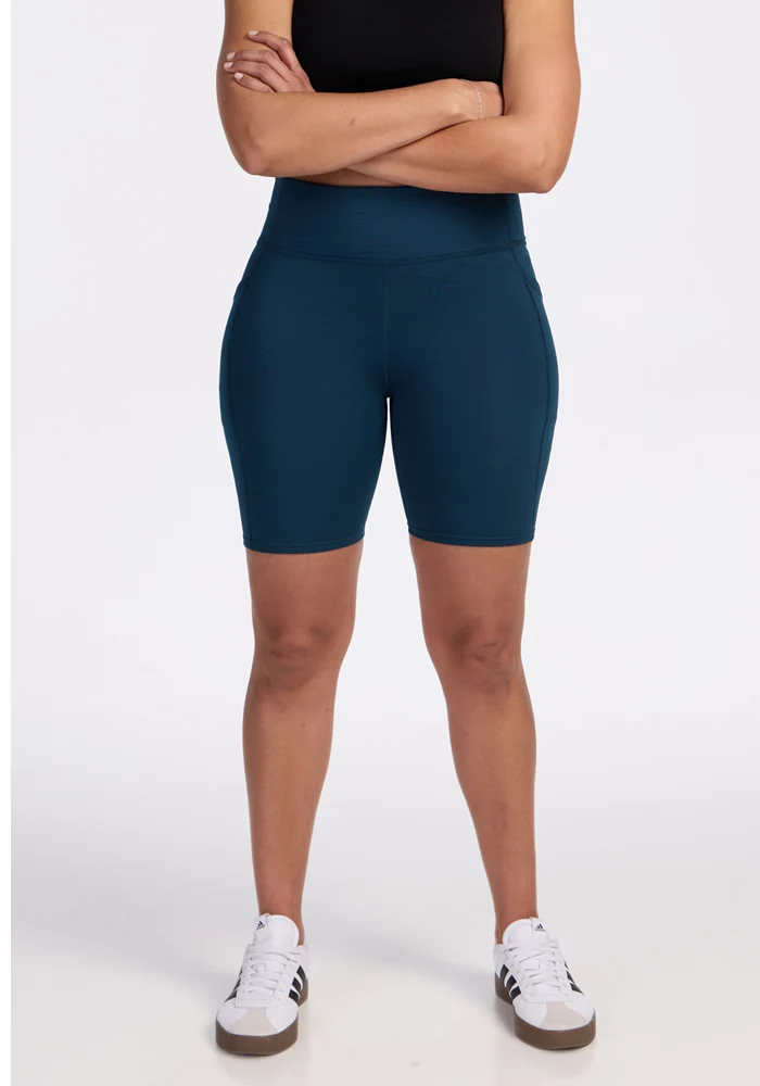 Bike shorts with visible side-pocket area on a plain background