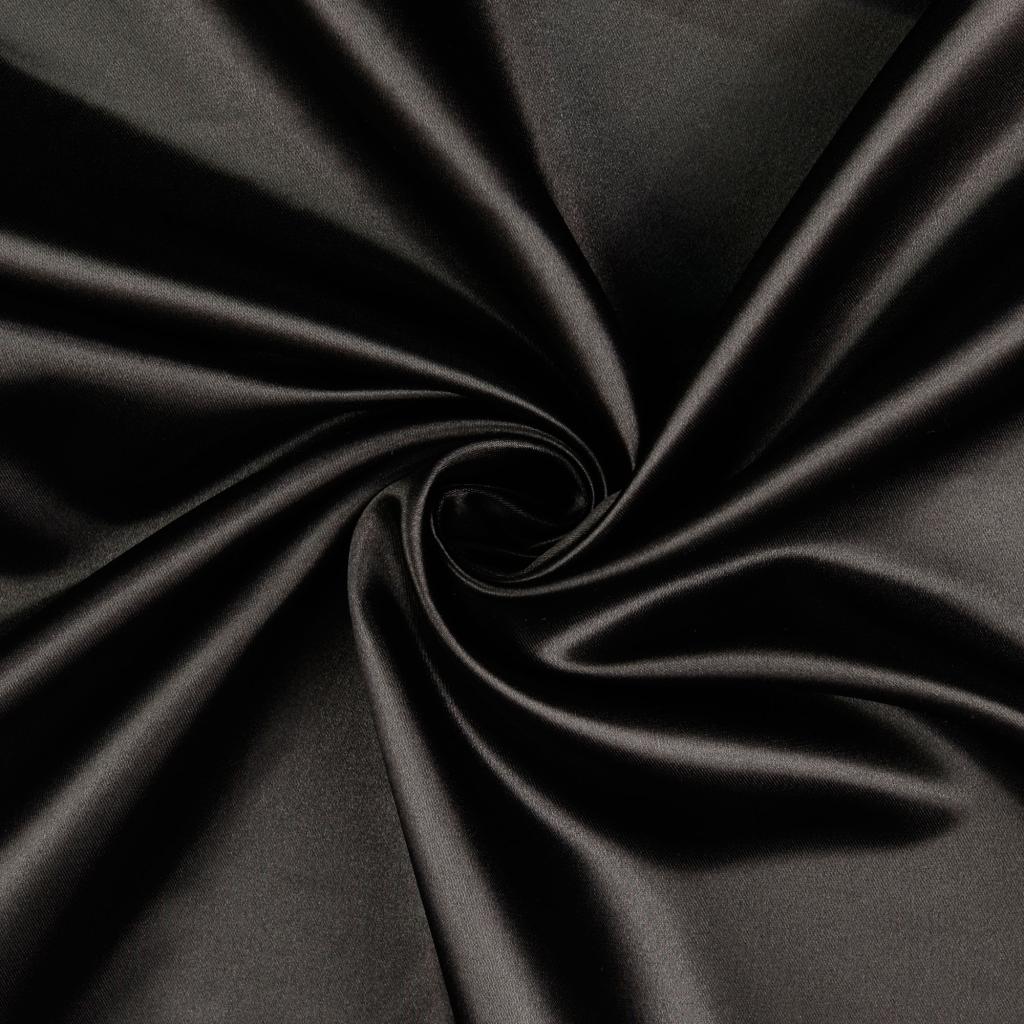 Black satin fabric in glossy folds