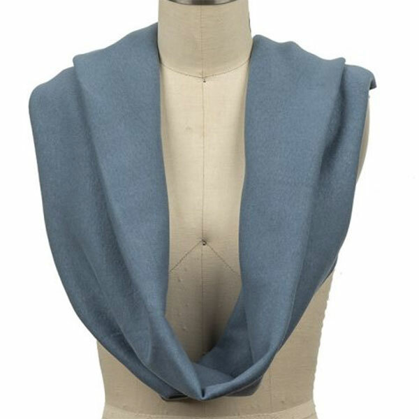 Blue tubular ribbing draped in a continuous loop around a dress form.