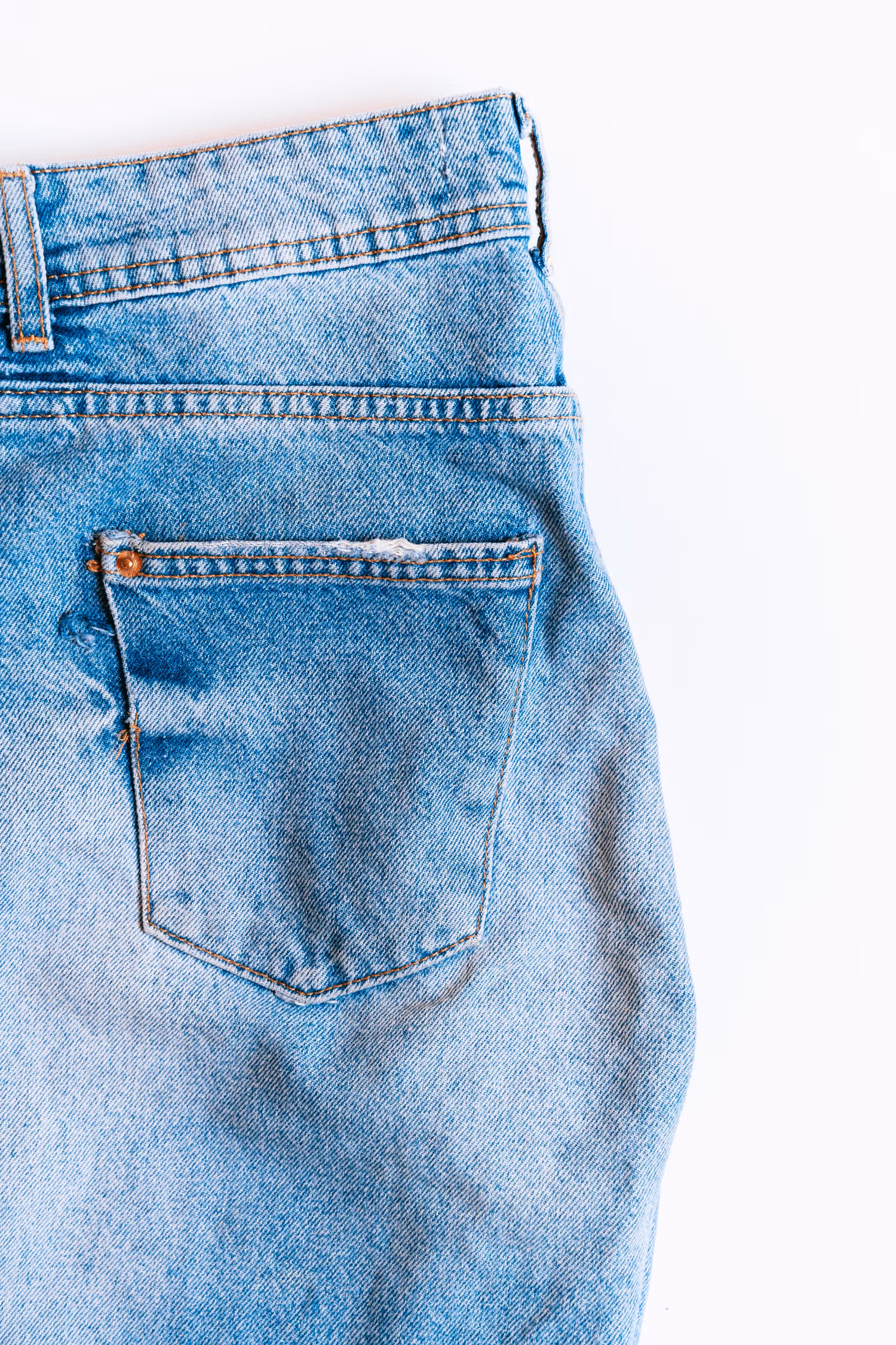 Close-up of a denim back pocket showing pocket shape, placement and stitching