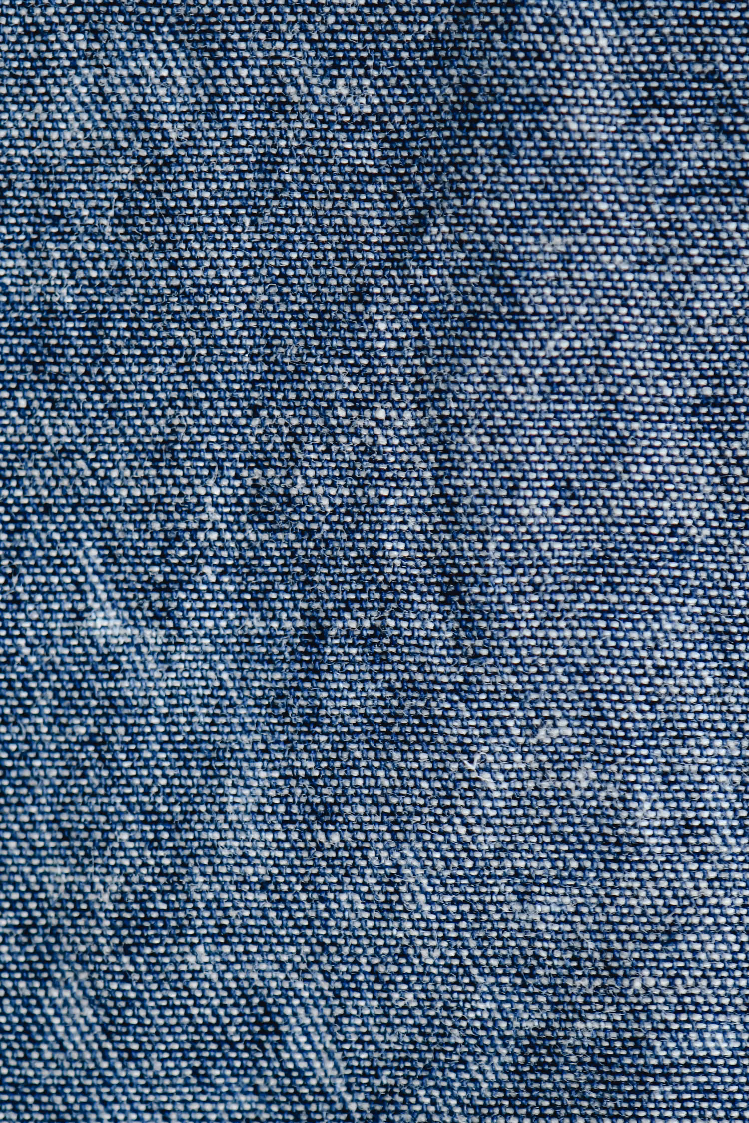 Close-up of blue denim fabric showing the diagonal twill structure