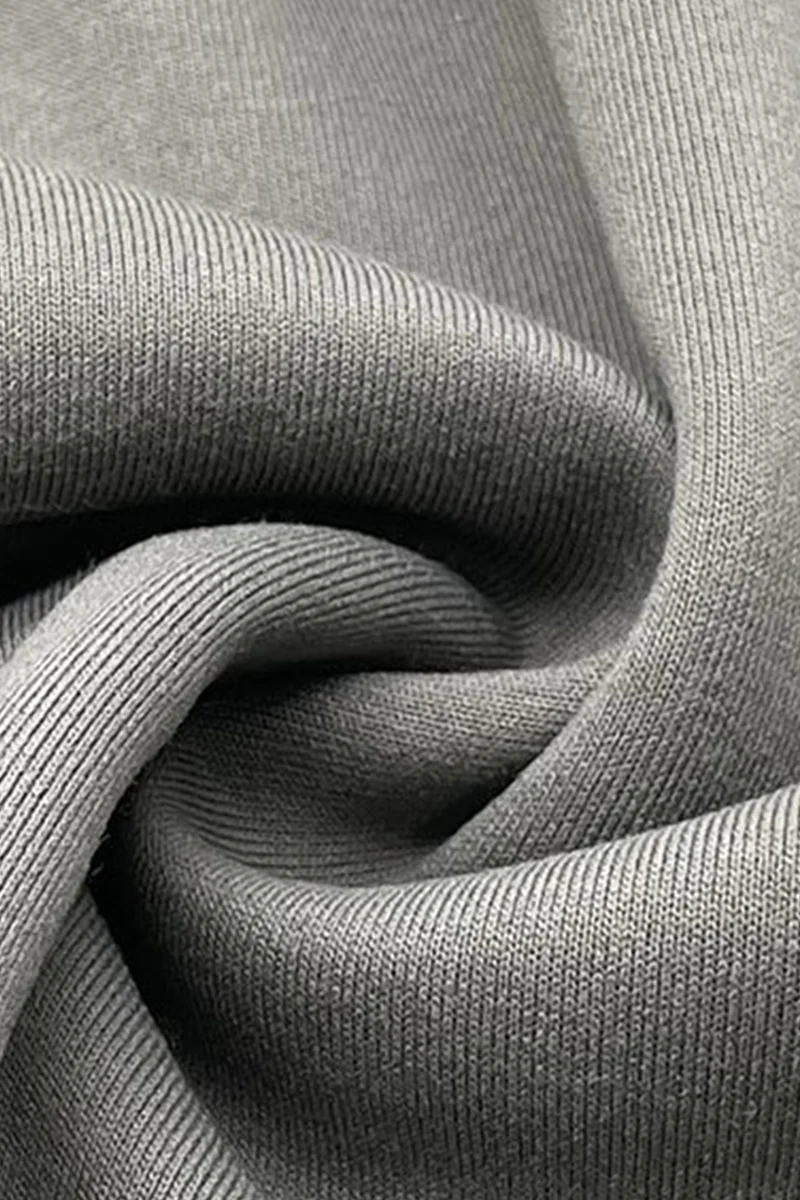 Close-up of grey sweatshirt knit fabric showing its surface and folds