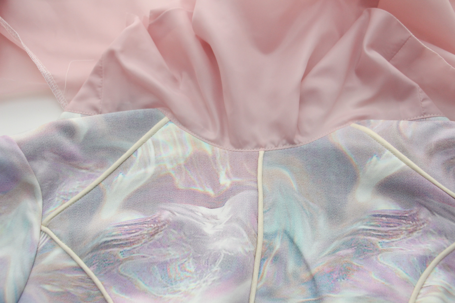 Construction reference: close view of the neckline join between pink lining and pale dress shell
