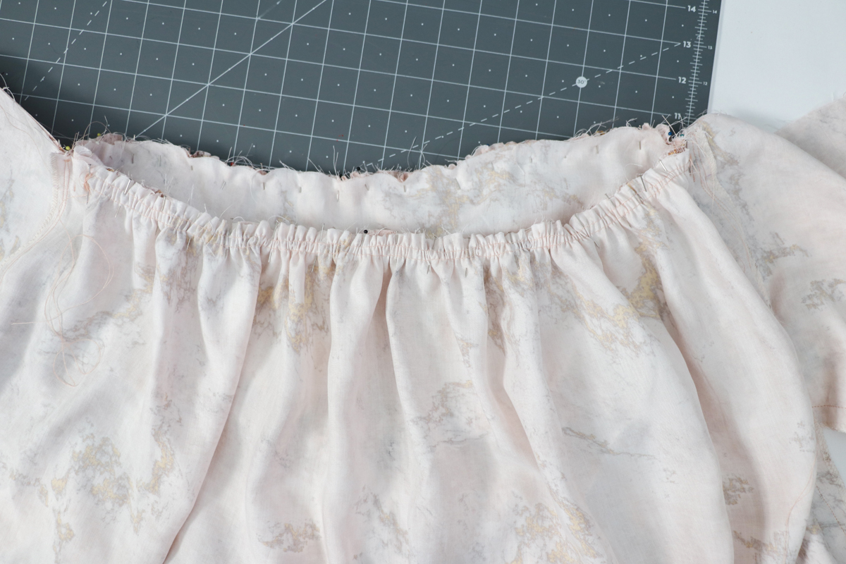 Construction reference: the gathered upper skirt edge pinned to the bodice along the waist joining seam
