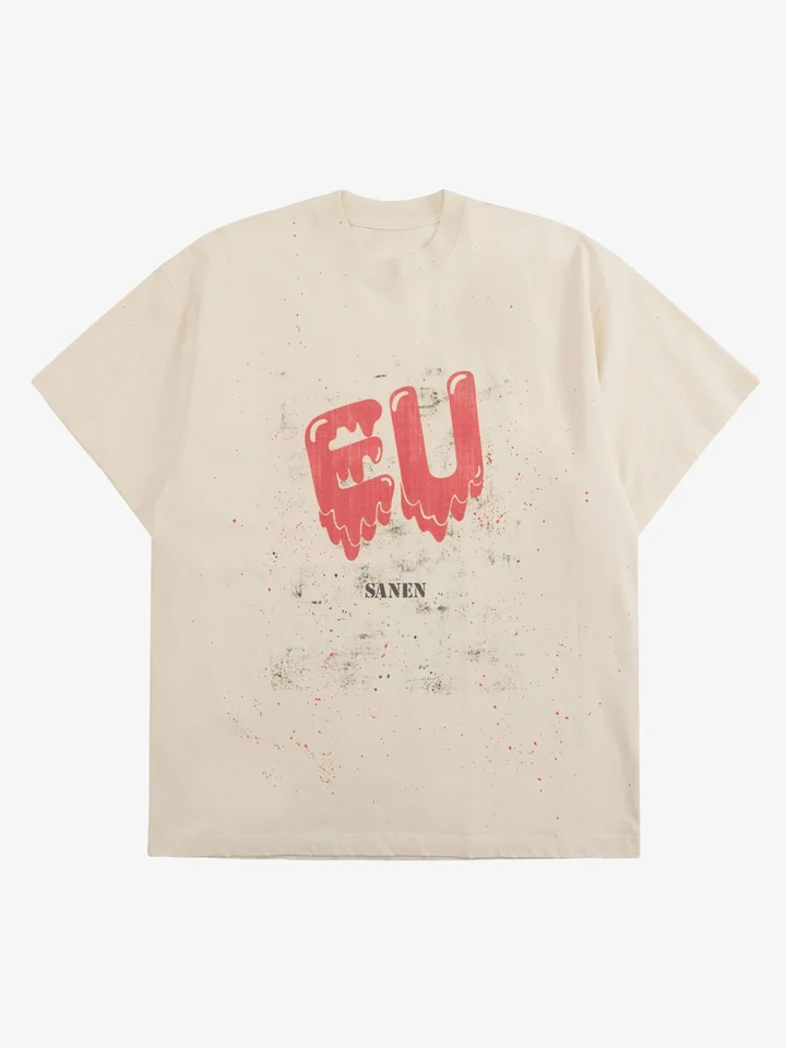 Cream T-shirt laid flat with a red chest graphic and a faded finish.