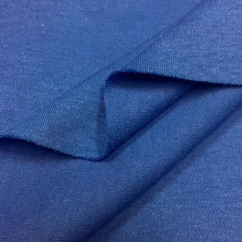Folded blue interlock knit fabric showing a smooth double-knit surface and substantial body.