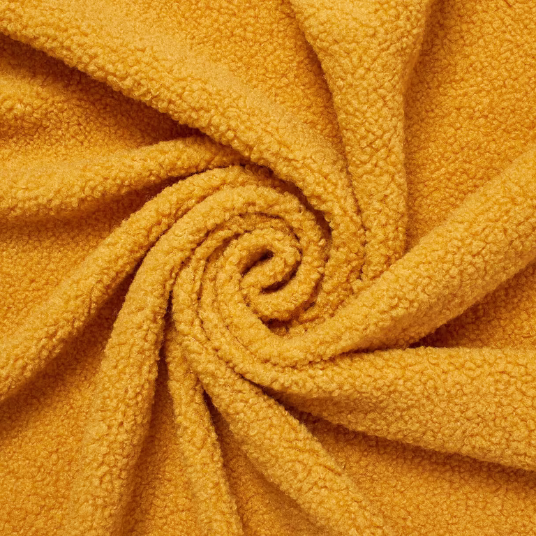 Gold 280 GSM sherpa fleece arranged in folds, showing a compact curly pile.
