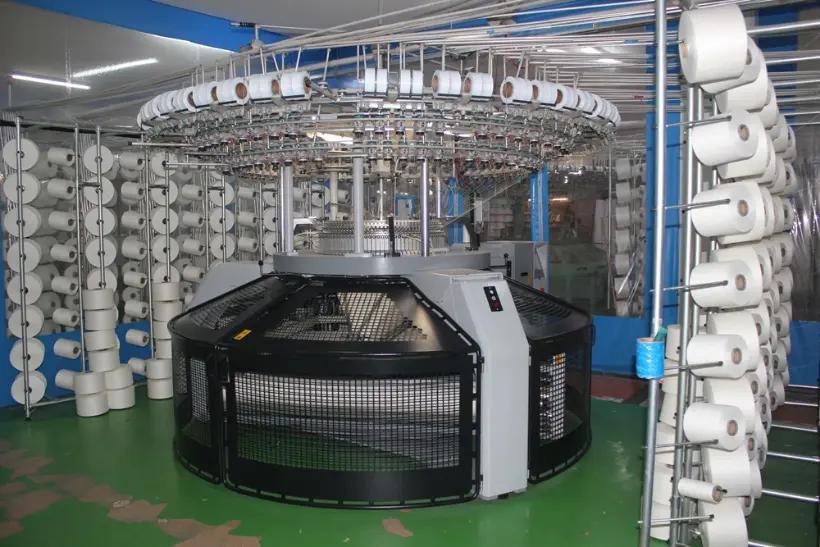 Industrial circular knitting machine used for double-knit and interlock fabric production.