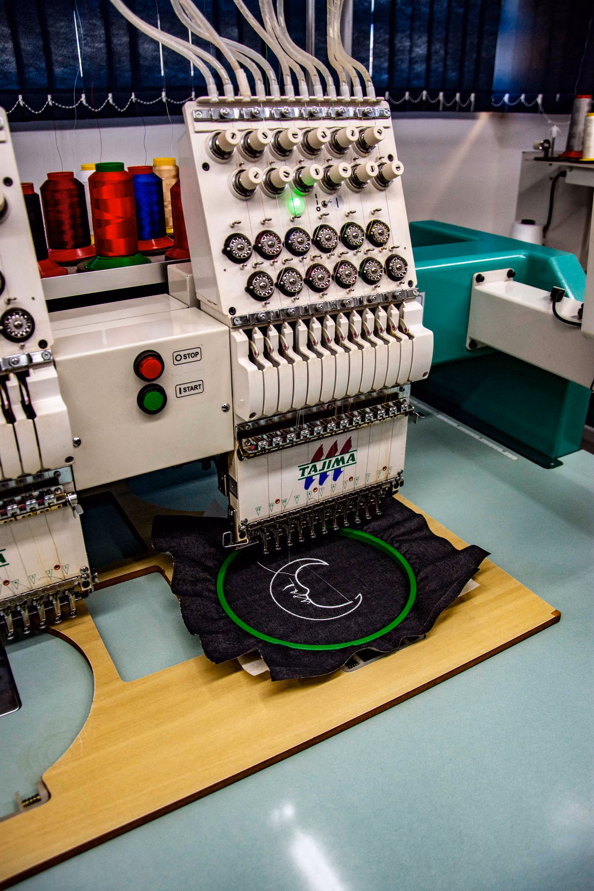 Industrial embroidery machine stitching garment panels