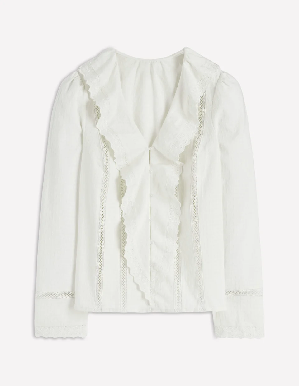 Ivory blouse with long sleeves, embroidered trim and ruffles down the front.