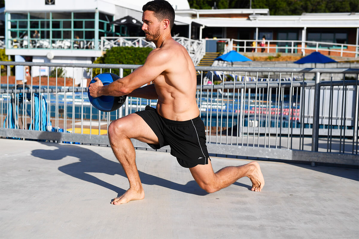 Loose black swim shorts with an elasticated waist, worn beside a pool