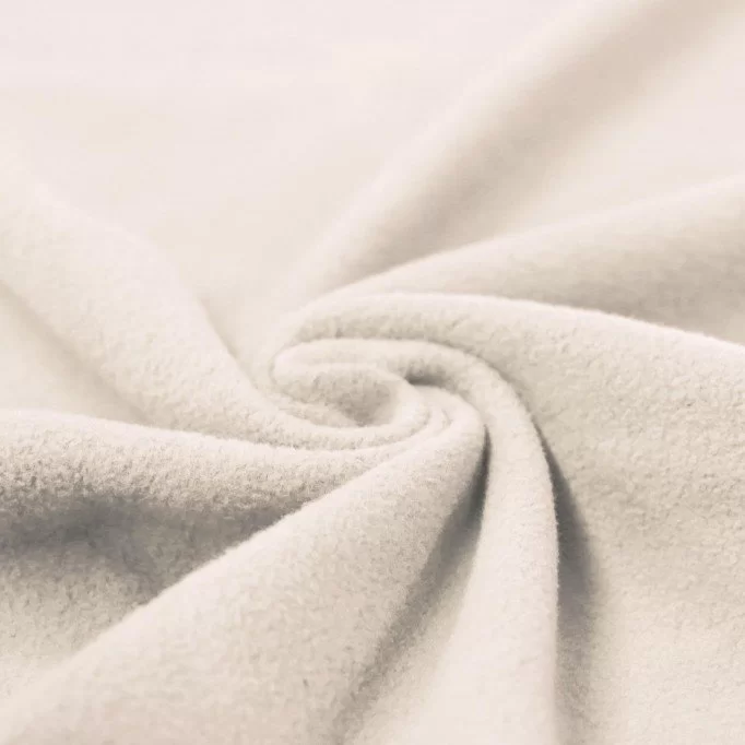 Natural cotton sherpa fabric showing the fluffy face of a four-way-stretch knitted quality.