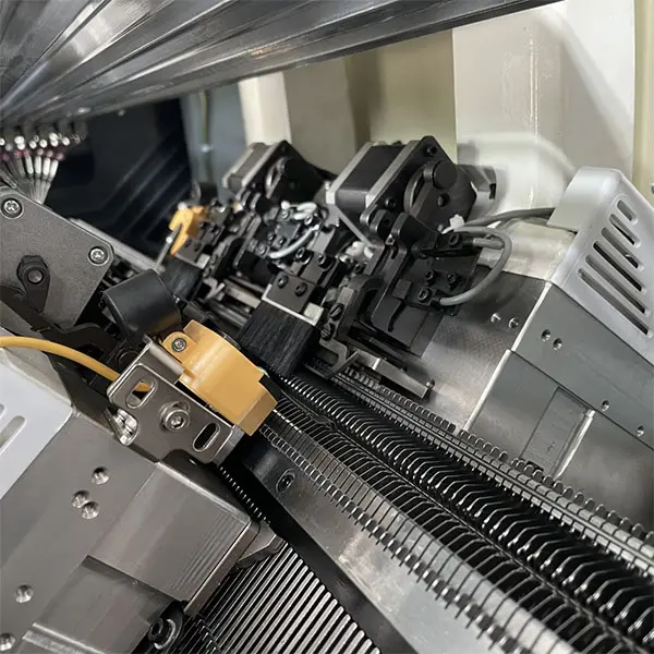 Needle bed and yarn-feed mechanism inside a knitting machine.
