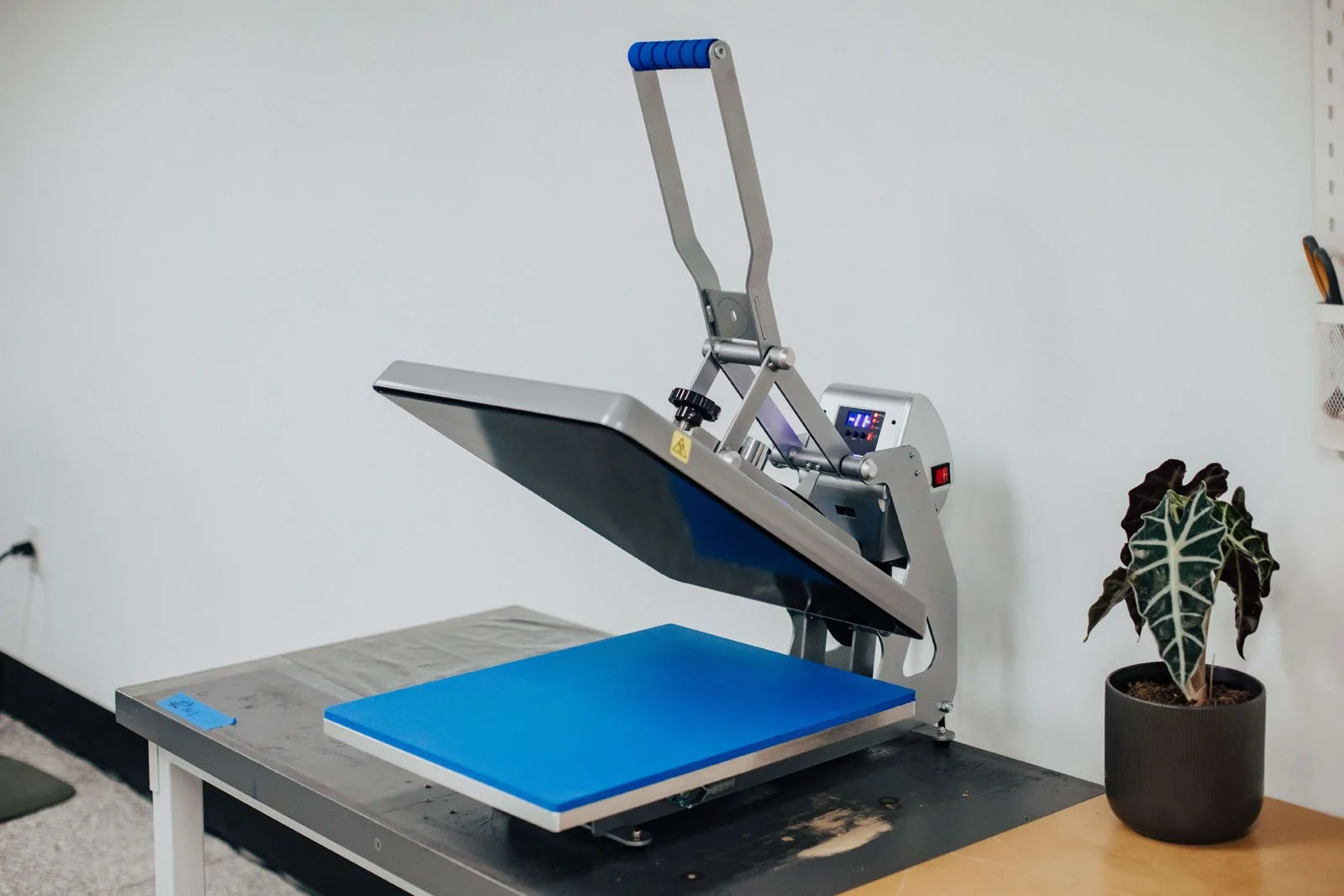 Professional flat heat press machine for garment transfer decoration.