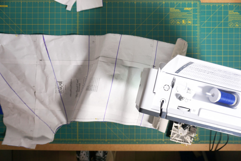 Quilting reference: marked coat panel quilting lines positioned at a sewing machine