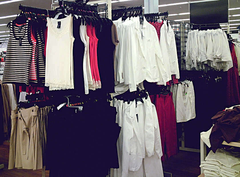 Ready-to-wear garments hanging together on a commercial rack