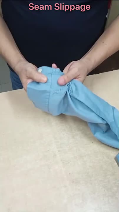 Seam being pulled to show slippage beside the stitch line