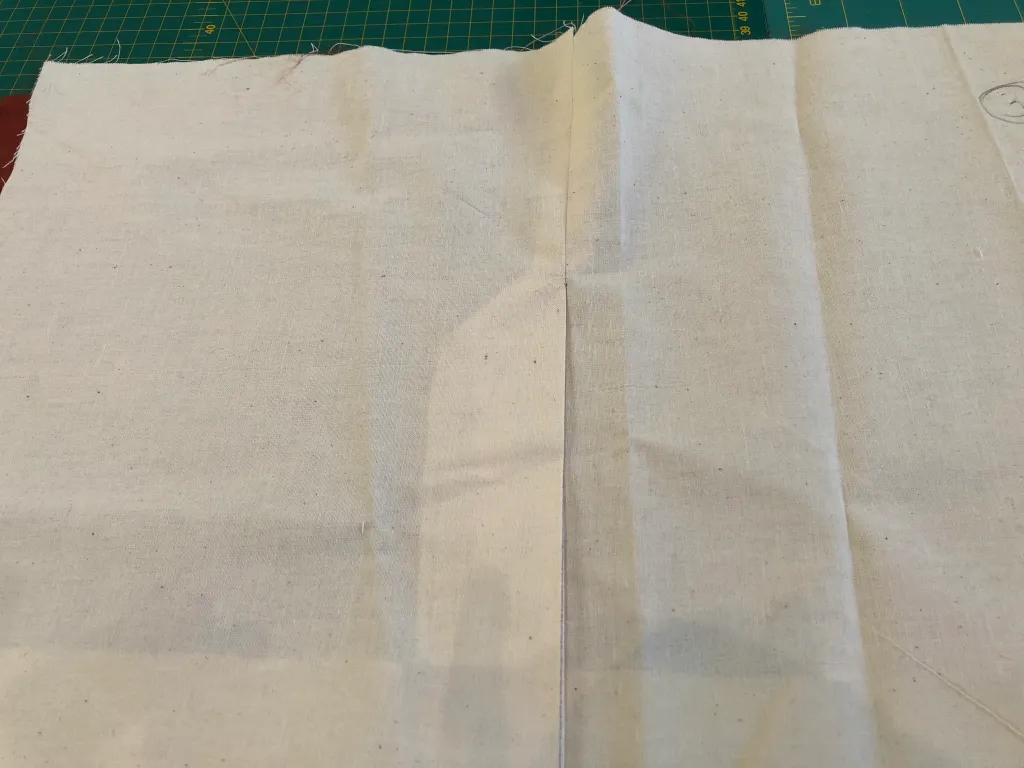 Sewn toile sample showing an overlapping skirt vent and its finished lower corner