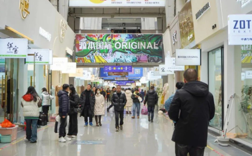 Shoppers and textile professionals walking through China Textile City in Keqiao, Shaoxing