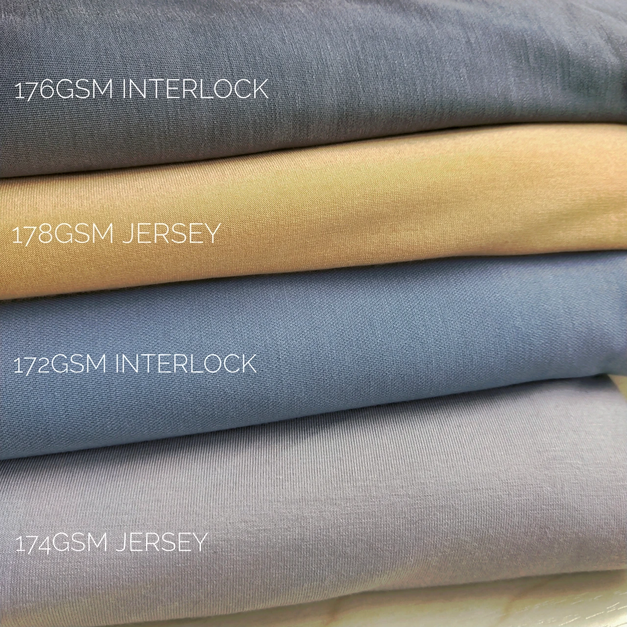 Stack of interlock and jersey fabrics with similar GSM labels showing different knit constructions.
