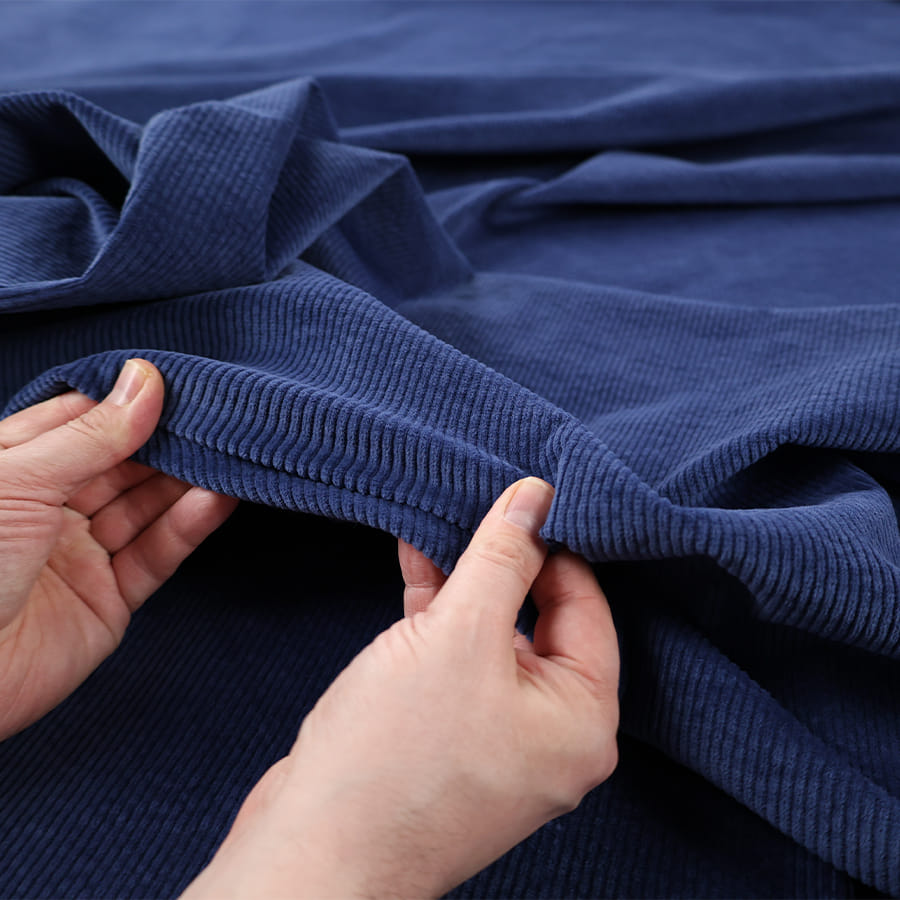Stretch corduroy being pulled