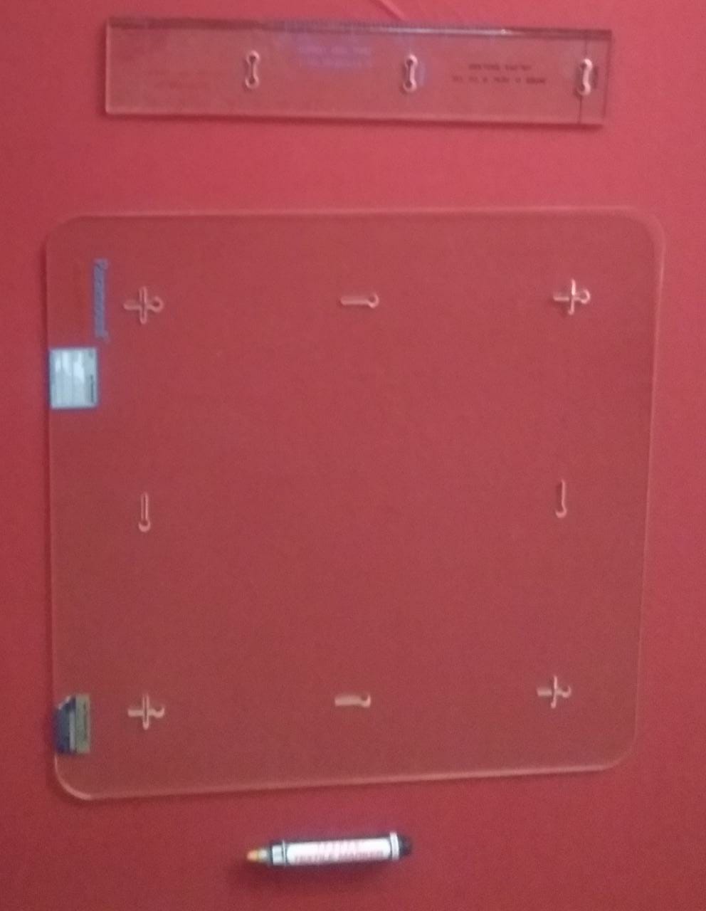 Textile shrinkage measuring template, scale and fabric marker used for dimensional-change testing.