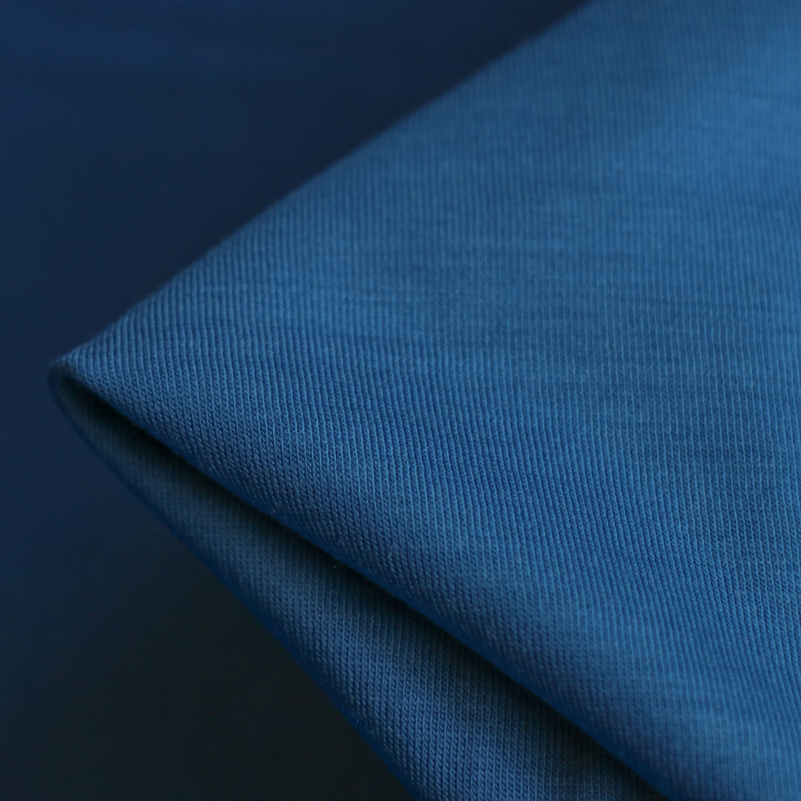 The knitted surface and folds of merino jersey.