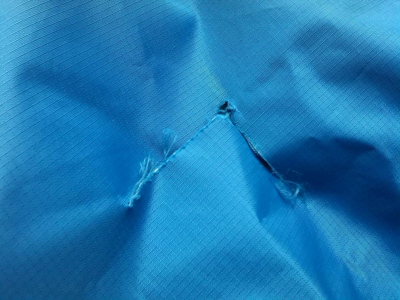 Torn ripstop fabric