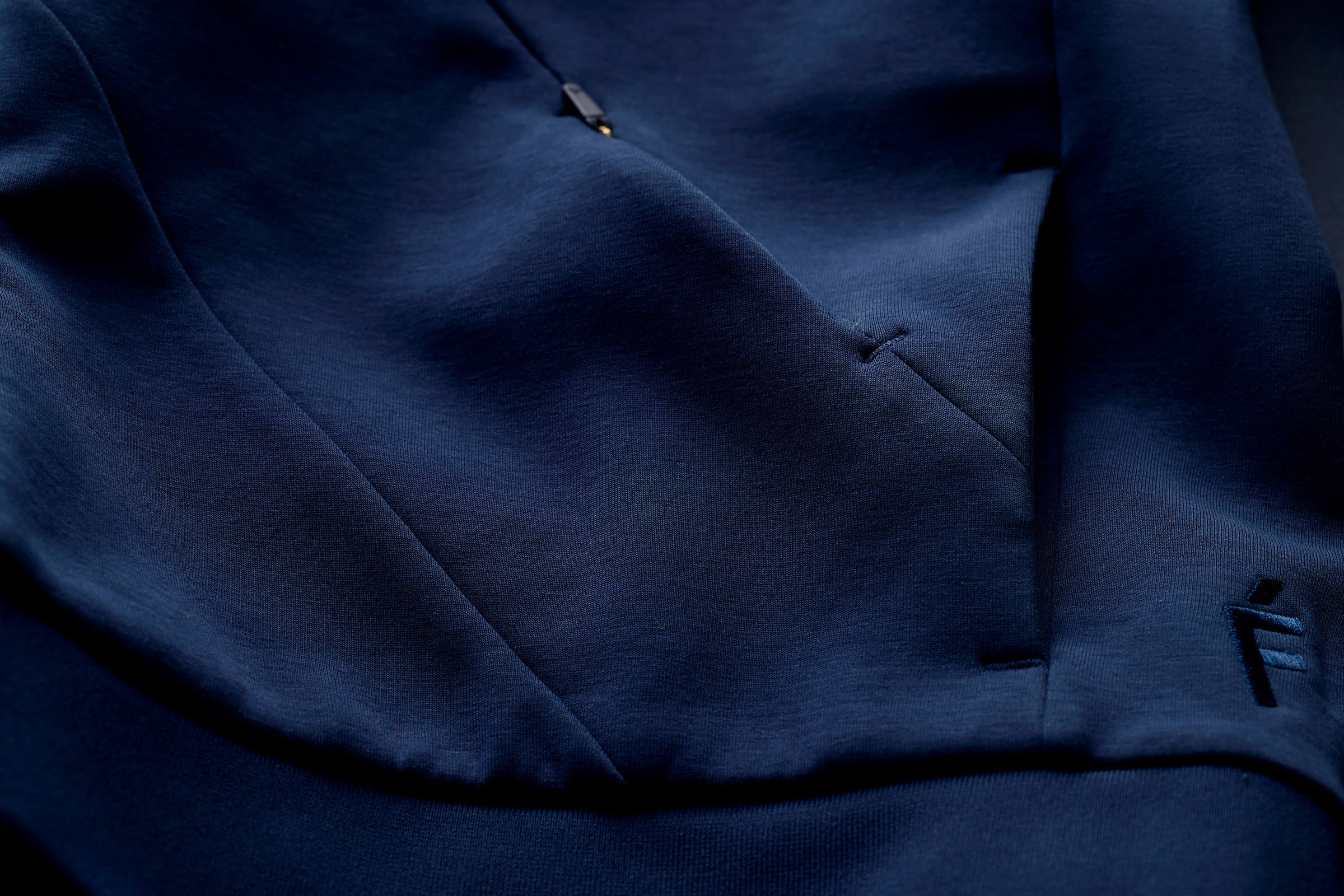 Track jacket sleeve cuff and ribbed hem photographed close up