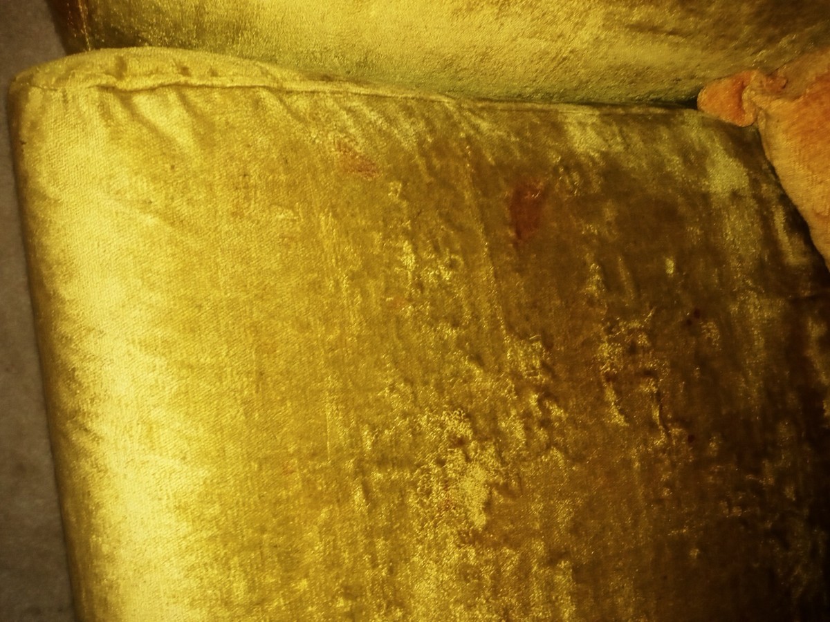 Velvet upholstery with visible flattened and differently reflecting pile from repeated use.