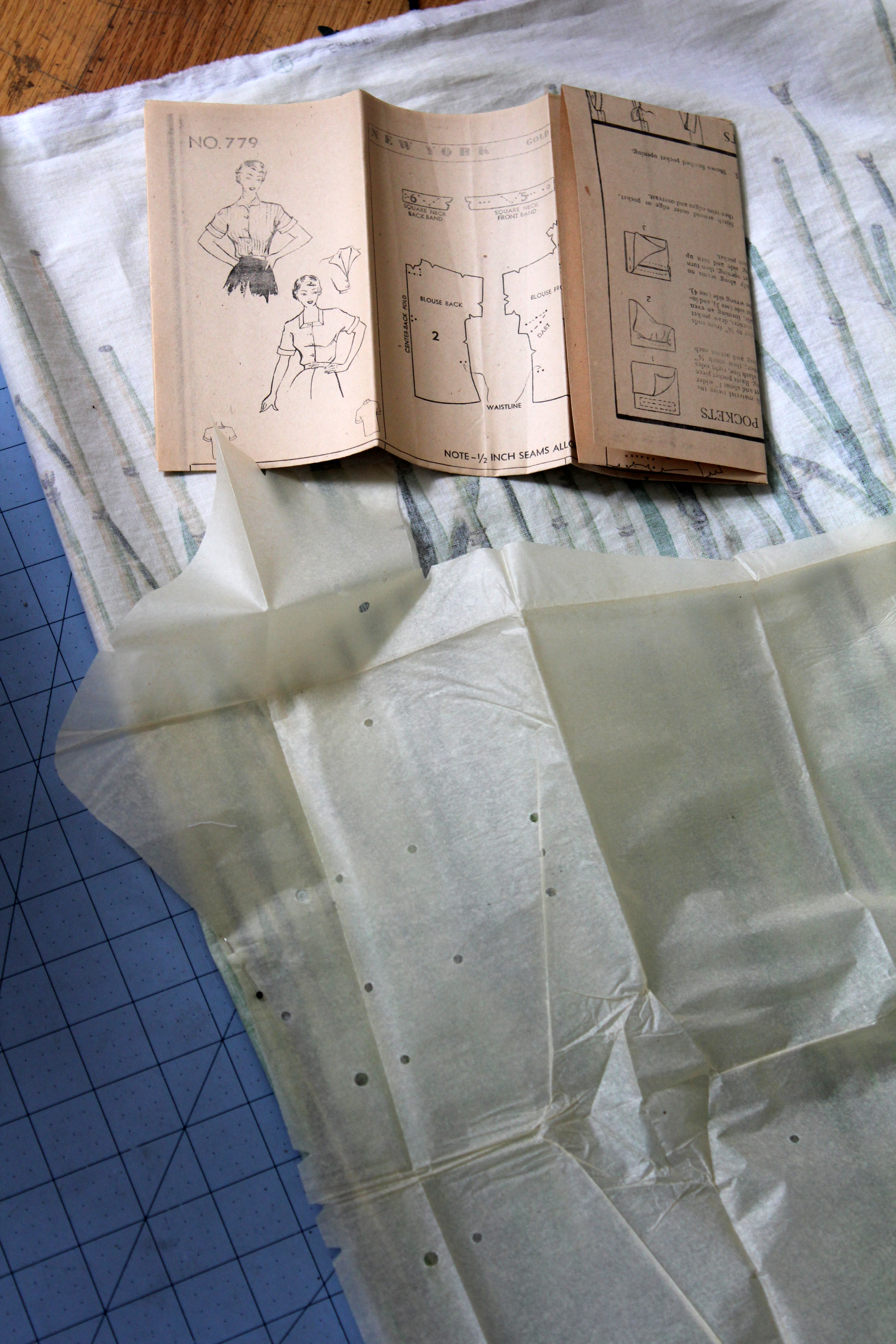 Vintage sewing pattern pieces spread out on a work surface, standing in for buyer-supplied pattern work in OEM clothing production