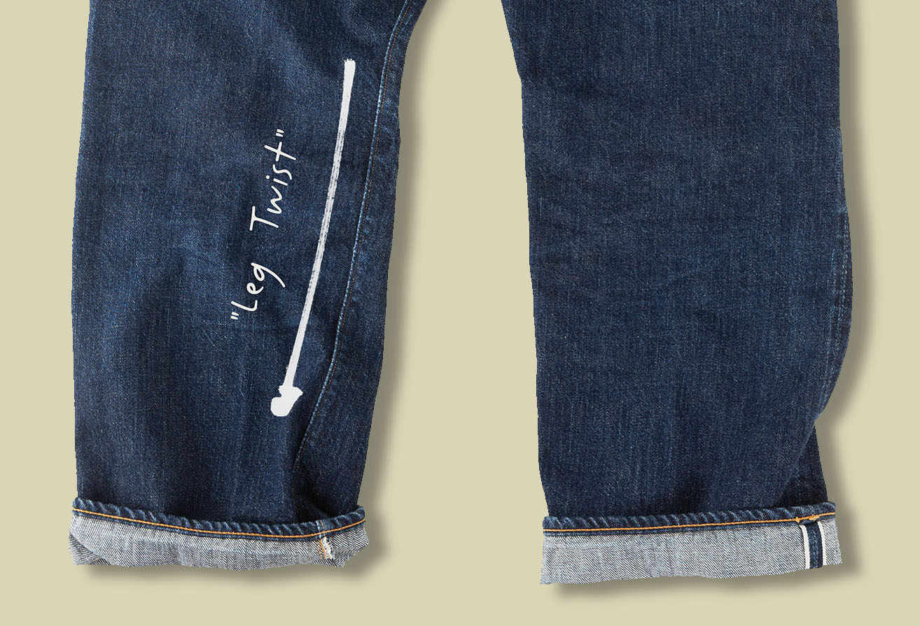 Washed denim leg showing visible seam rotation and leg twist toward the front