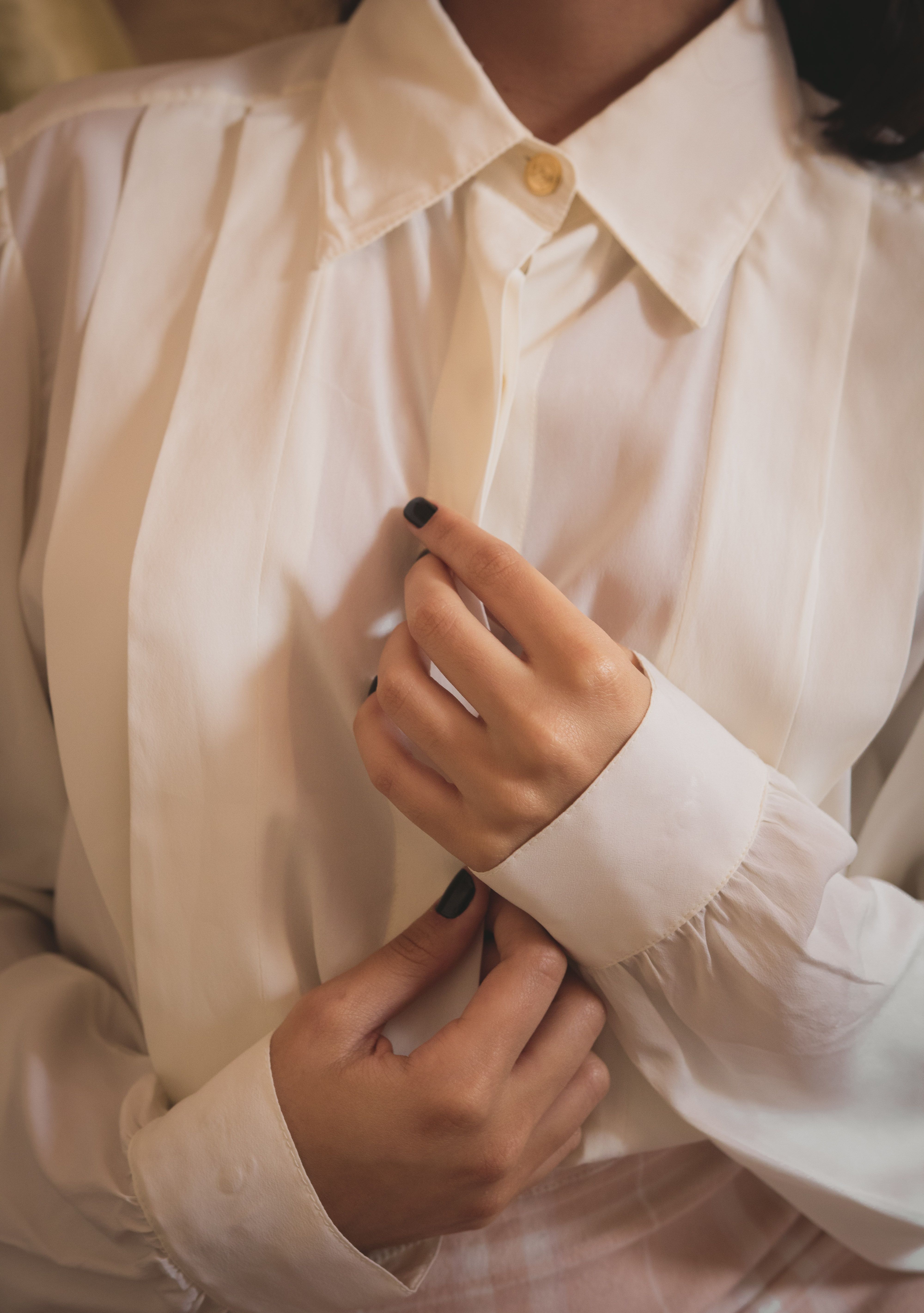 White blouse showing long sleeves and finished cuffs