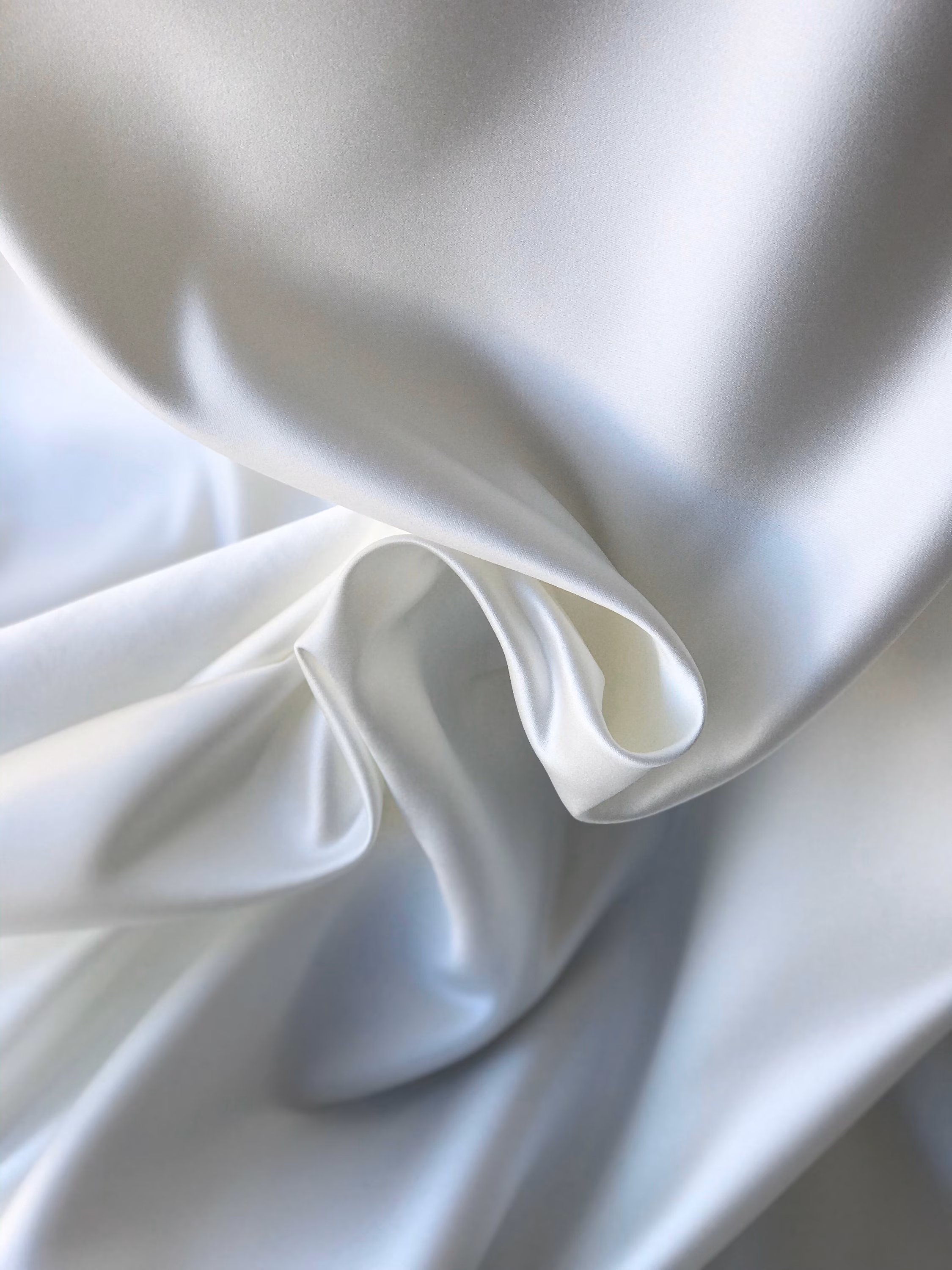 White duchess satin forming structured folds