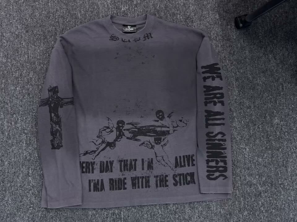 Finished waffle-knit long-sleeve garment with printed graphic zones.