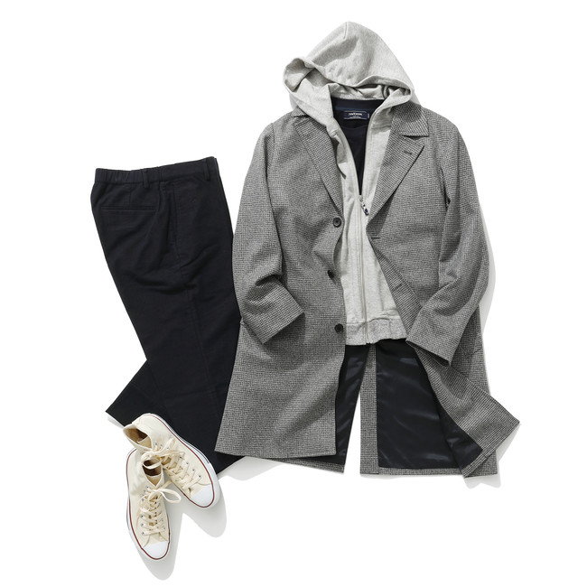 Coat layered over a hoodie showing the additional bulk created by a thick underlayer